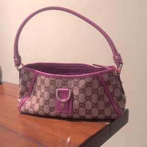 Authentic monogram Gucci handbag with pink leather strap and piping.